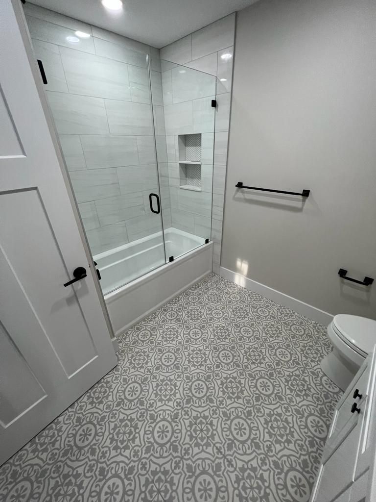 a bathroom with a bathtub, toilet and shower