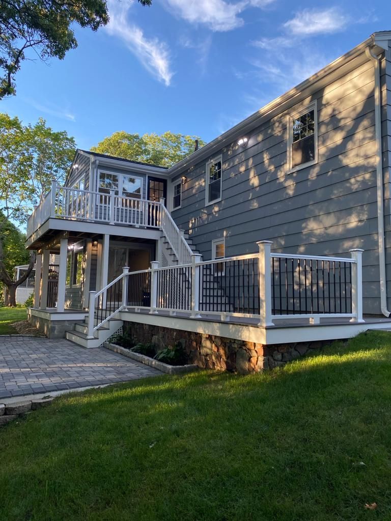the back of a house with a large deck and stairs
