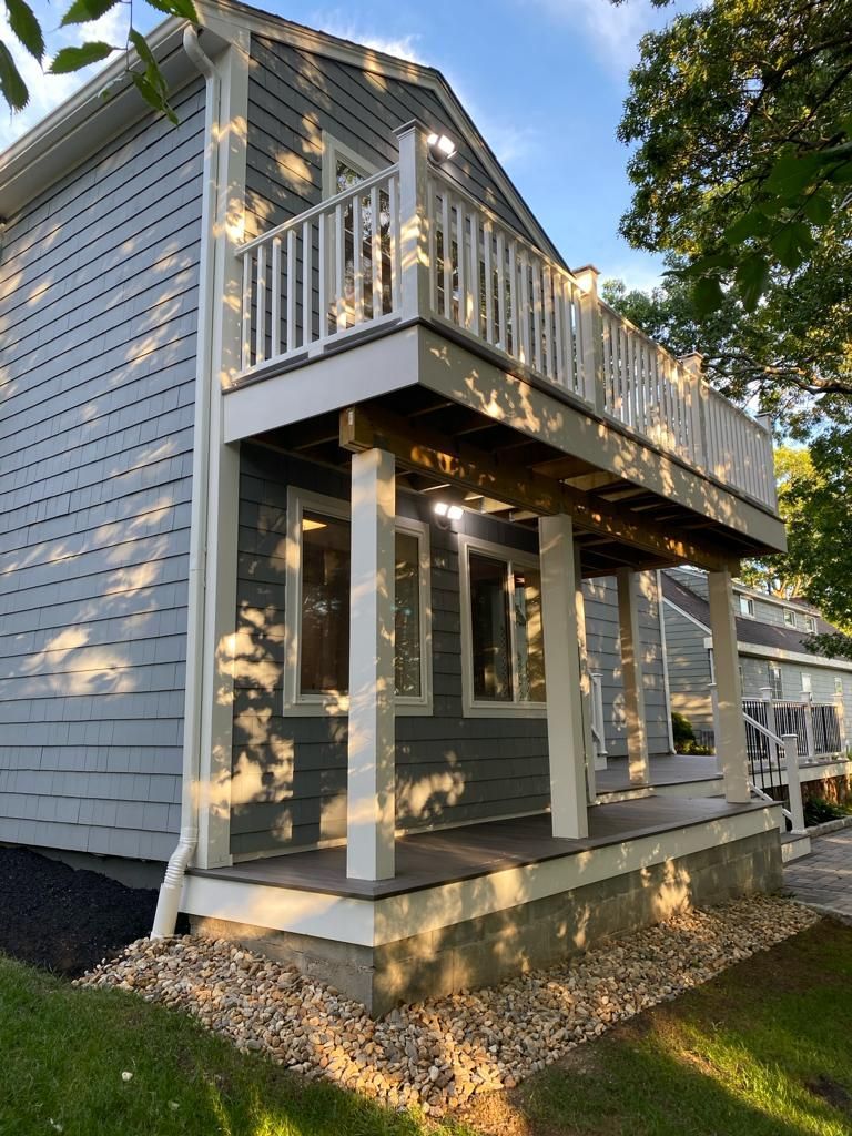 a small house with a large porch and a balcony