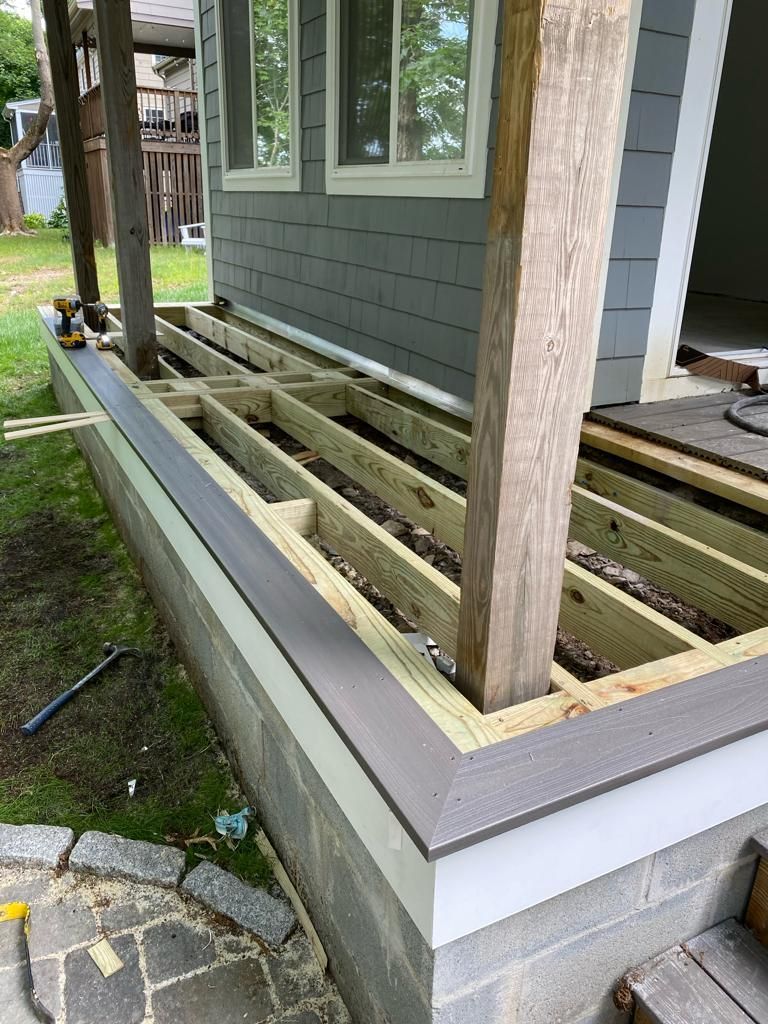 a wooden deck is being built on the side of a house
