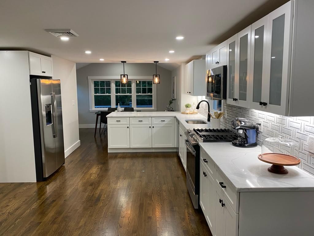 a kitchen with white cabinets and stainless steel appliances