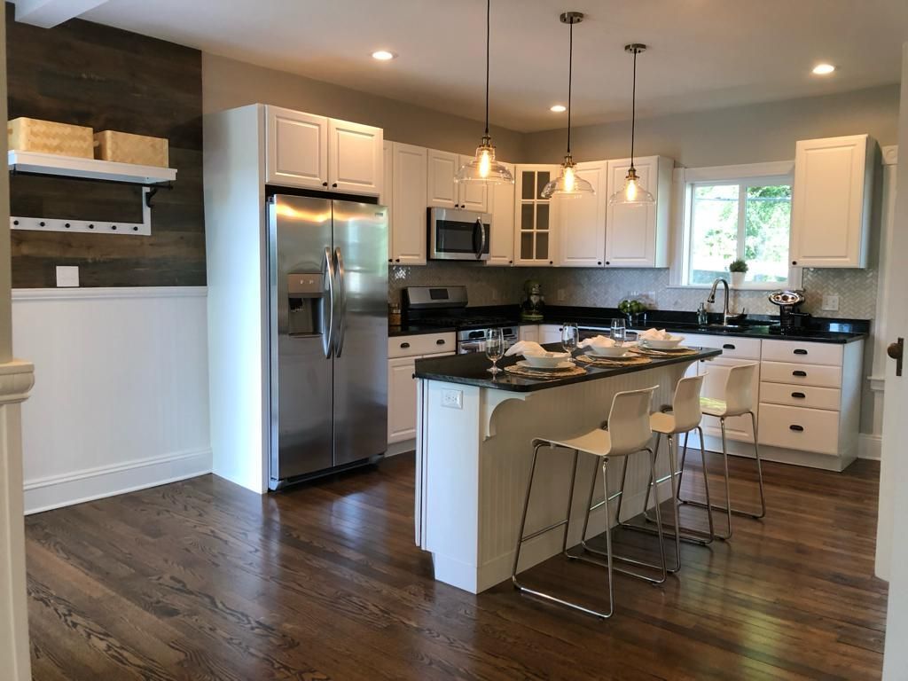 a kitchen with white cabinets and stainless steel appliances