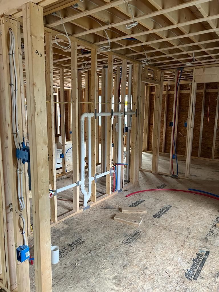 a house is being built with wooden beams and pipes