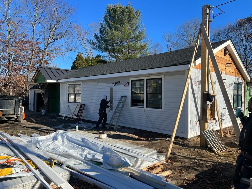 a man is painting the side of a house