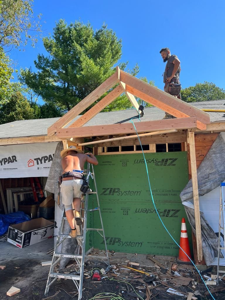 a man is standing on a ladder in front of a building under construction