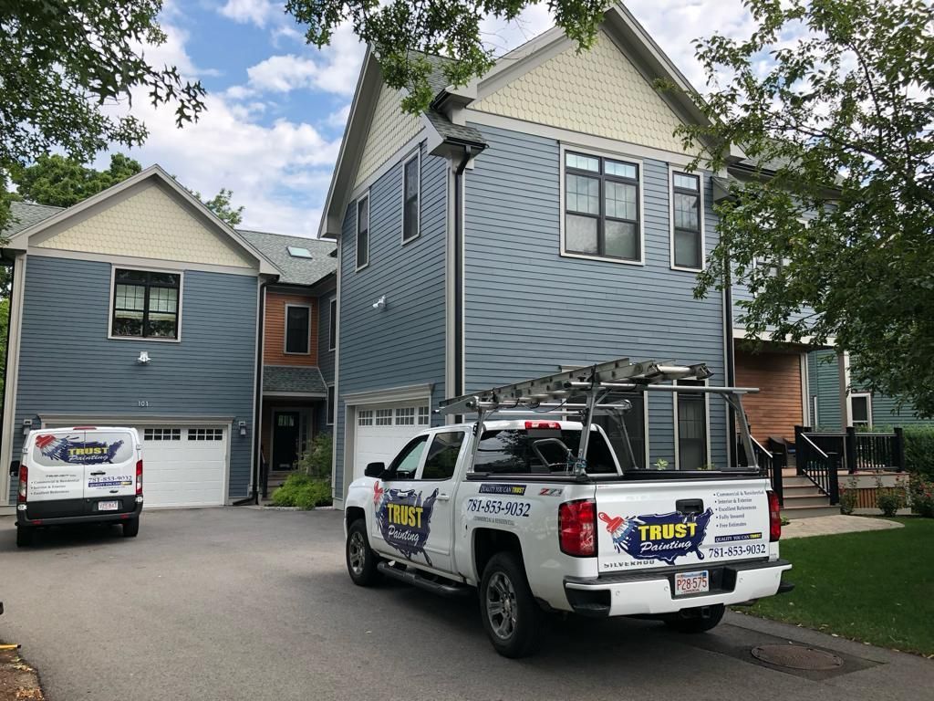 a white truck is parked in front of a house