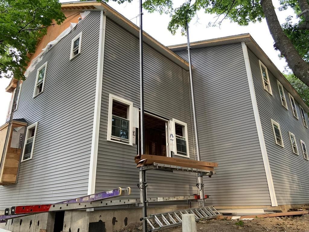a house under construction with a ladder on the side of it
