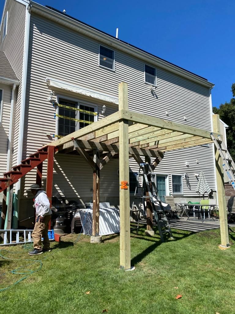 a wooden pergola is being built in the backyard of a house