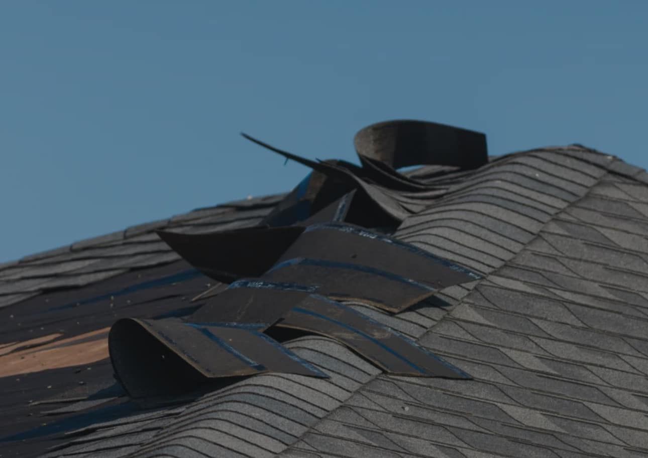 A close up of a roof with a blue sky in the background