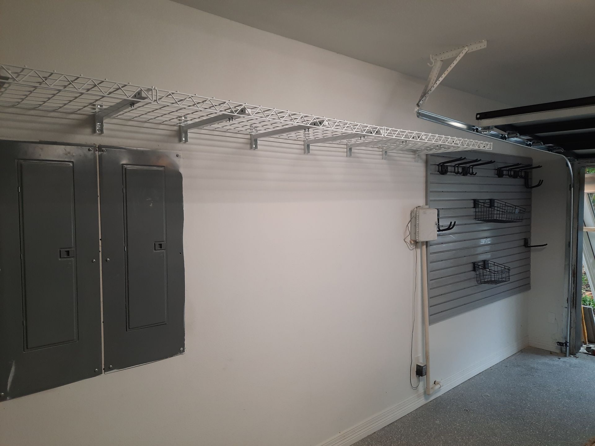 A garage with a lot of shelves and boxes on the wall.