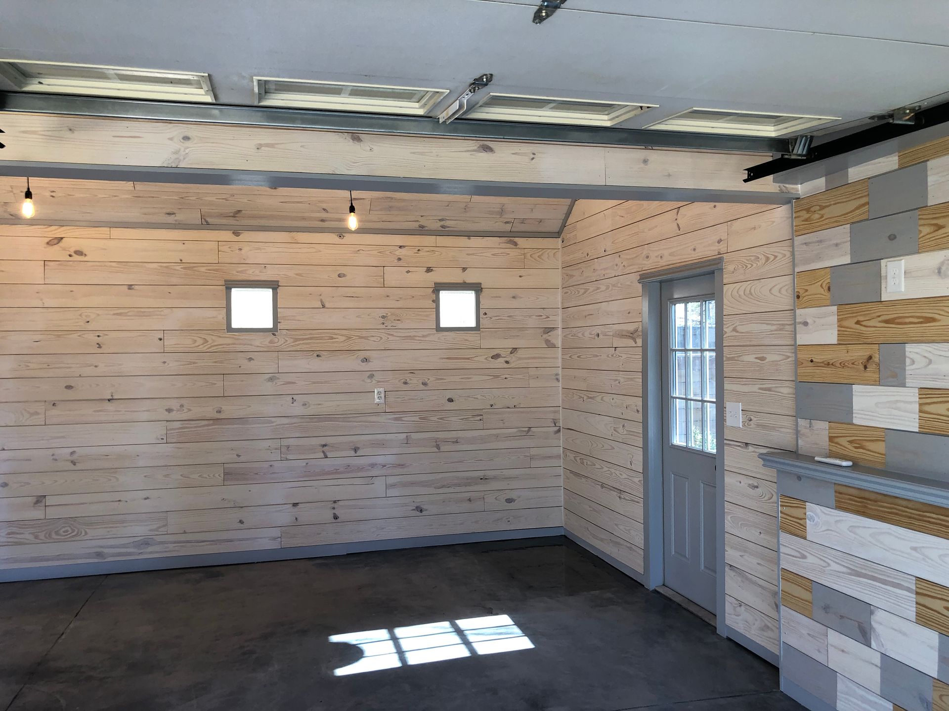 An empty room with wooden walls and a door