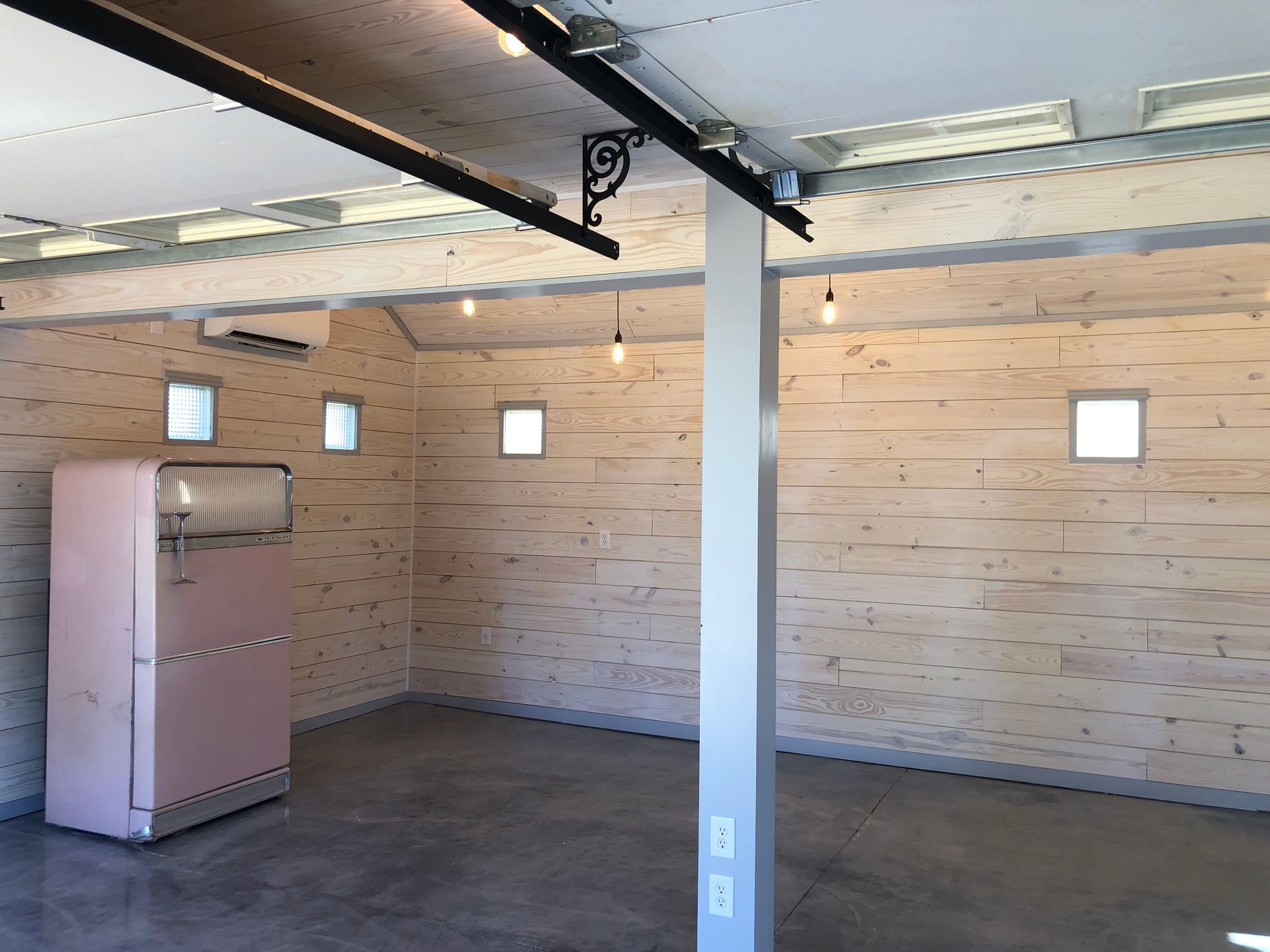 An empty room with a pink refrigerator in it