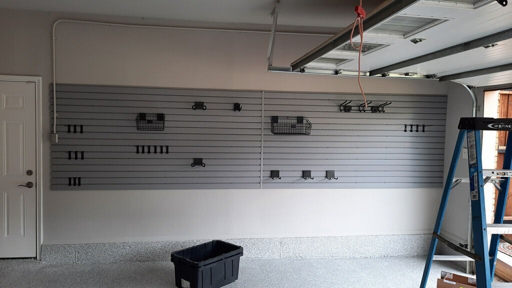 A garage with a garage door open and a ladder.