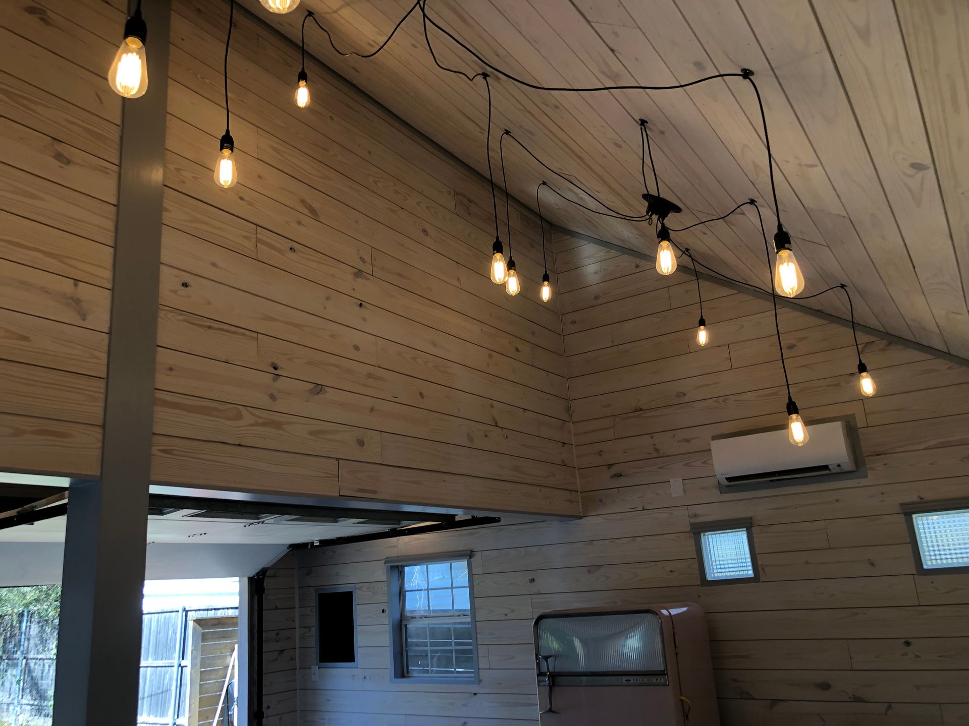 A room with a lot of lights hanging from the ceiling