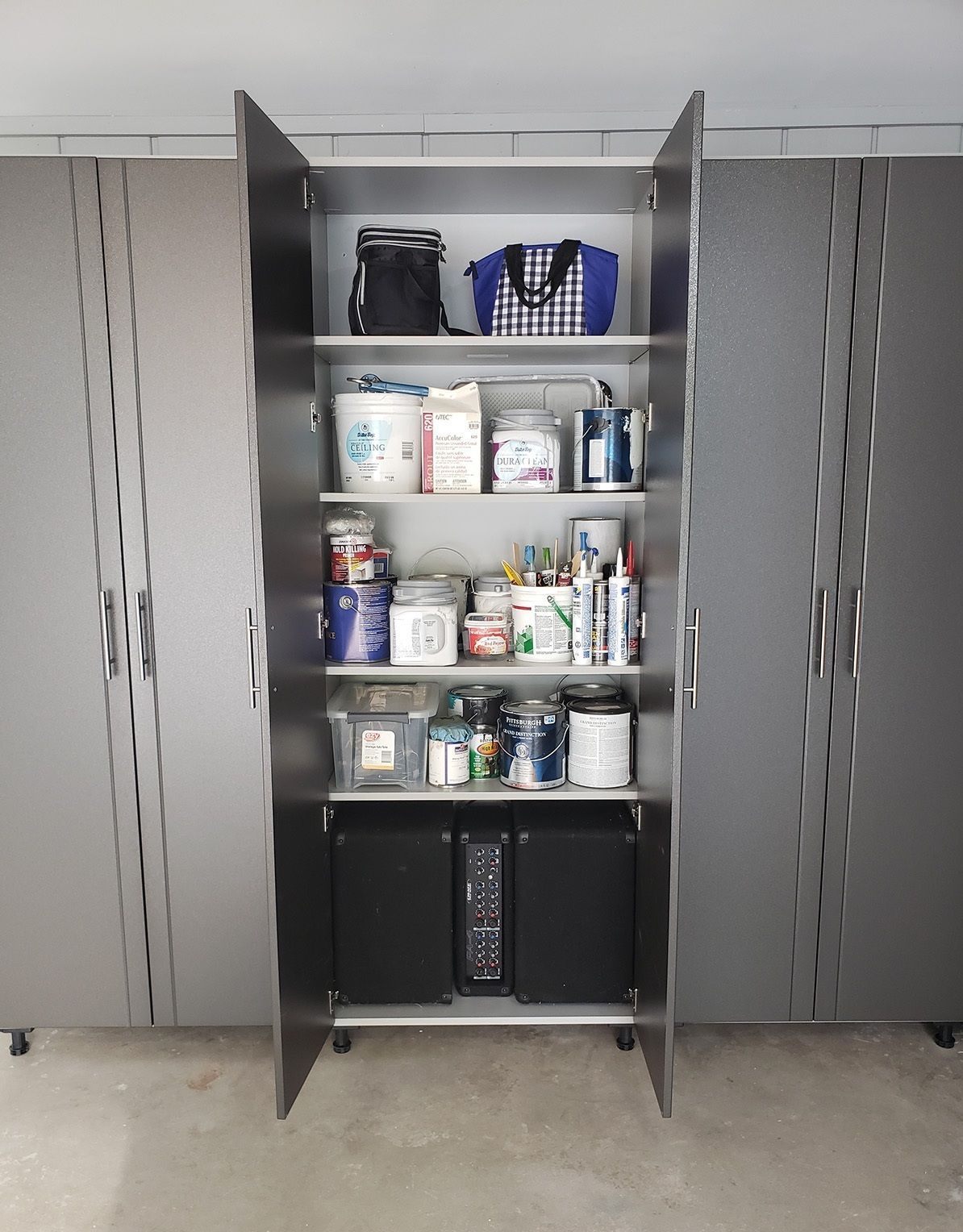 A closet filled with lots of items including a computer