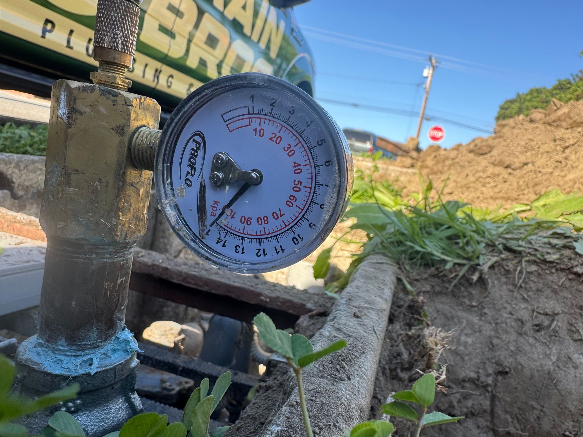 Pressure gauge shows 10 PSI in an outdoor setting, with a work truck visible in the background.