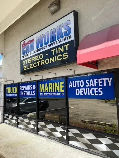 Storefront signs for truck repairs, marine electronics, stereo-tint electronics, and auto safety devices