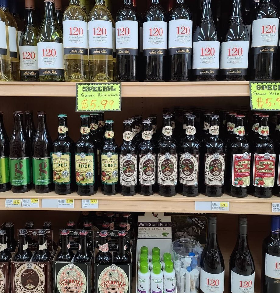 Shelves of wine and beer bottles in a store, with a 