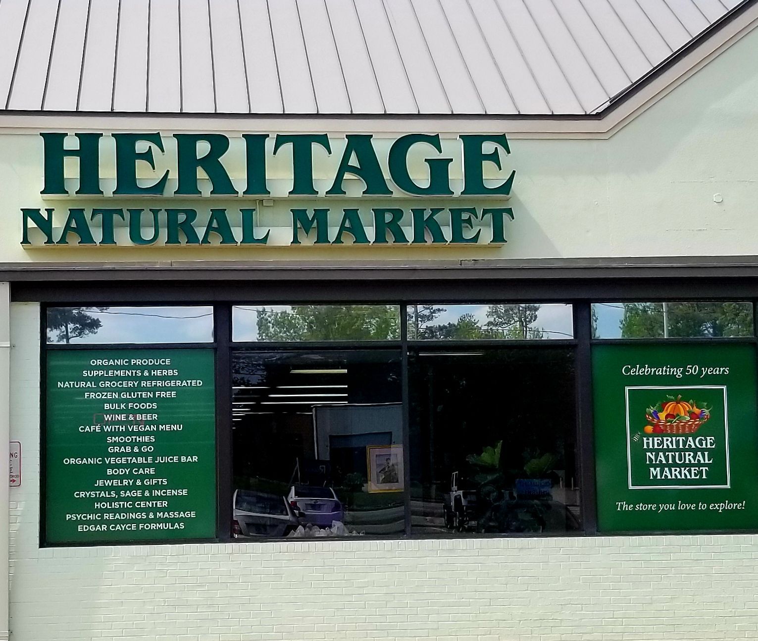Heritage Natural Market storefront with green signage and tinted windows.