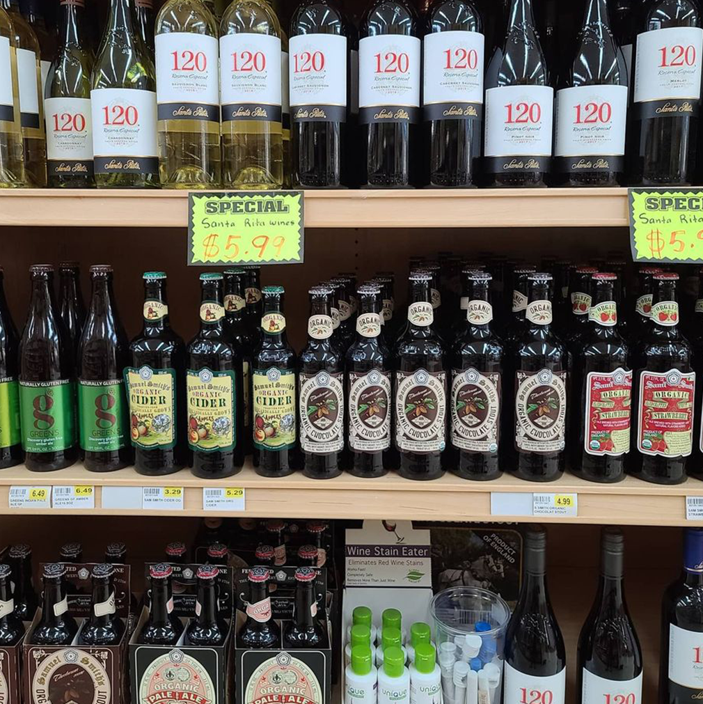 Shelves of wine and cider bottles in a store, with
