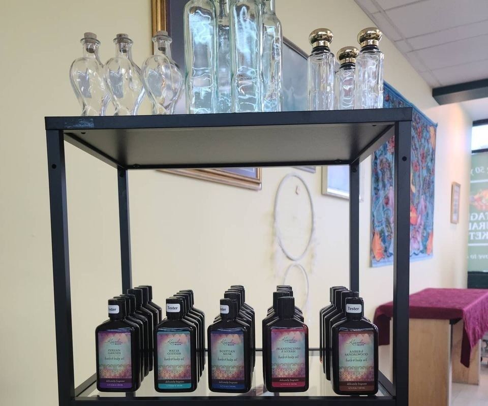 Shelf with various glass bottles on display in a store setting.