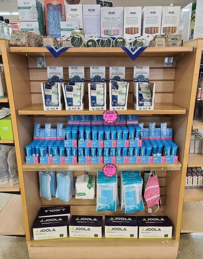 Wooden shelves stocked with blue and white health and hygiene products.