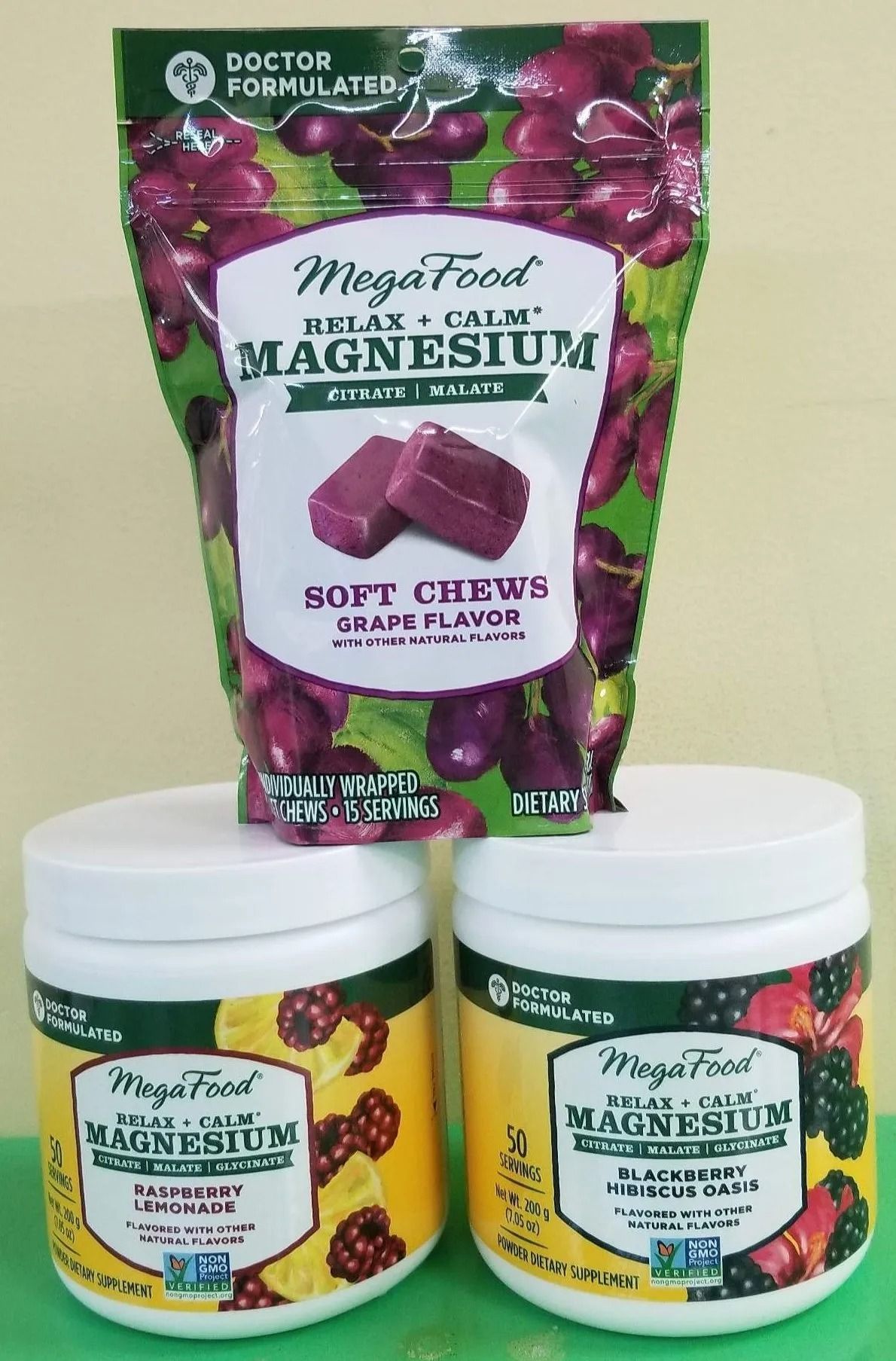 MegaFood magnesium supplements: grape-flavored soft chews, and powder tubs in yellow and white containers.