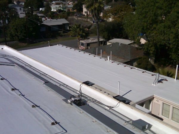 A white roof with a few wires on it