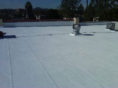 A white roof with a fan on top of it.