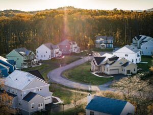 An aerial view of a residential neighborhood with houses and trees in the background.