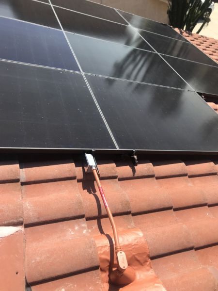 A row of solar panels on a tiled roof