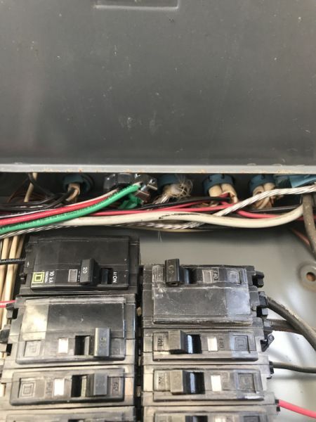 A bunch of wires are coming out of a electrical box