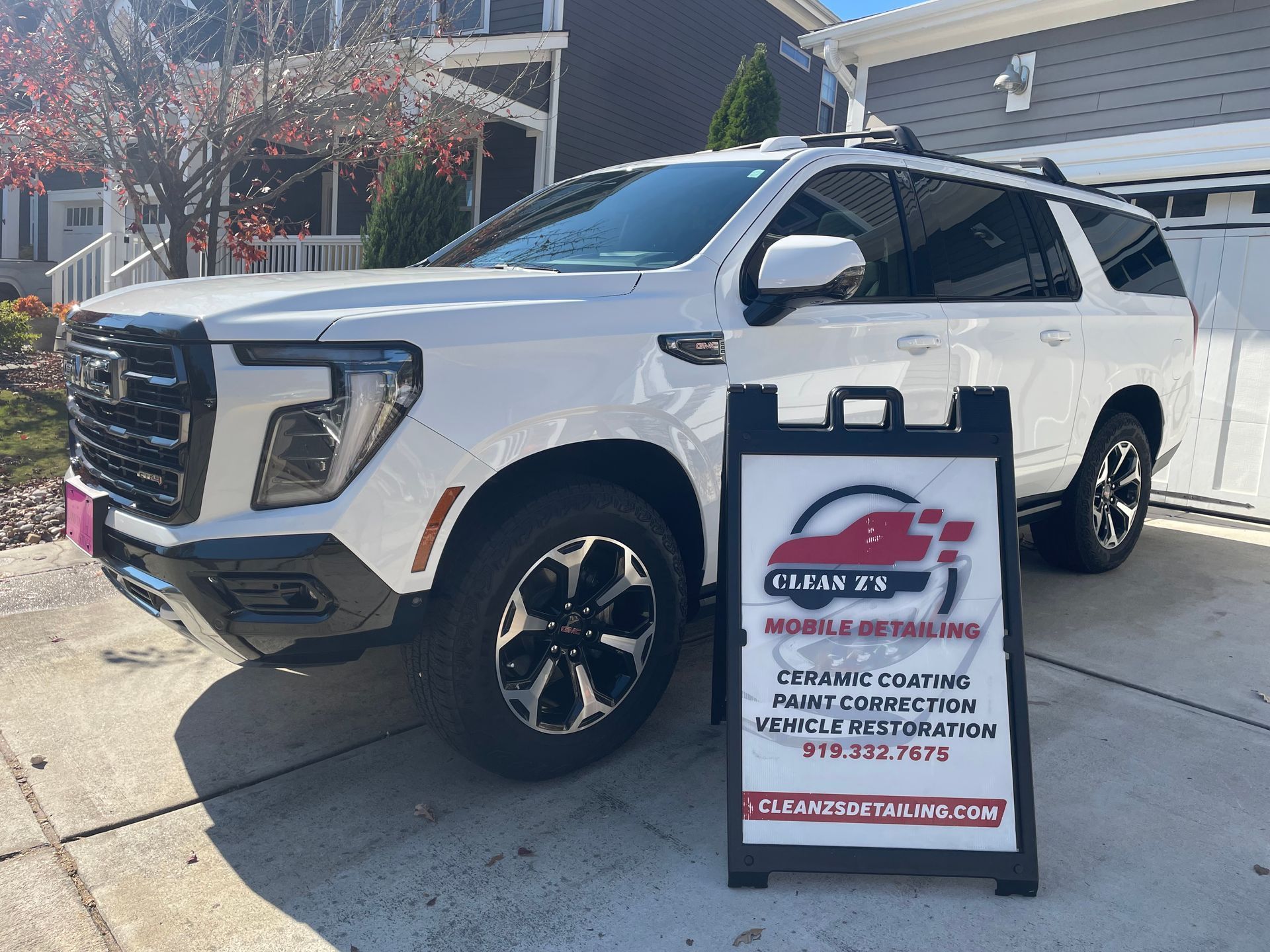 White SUV parked in front of a house.