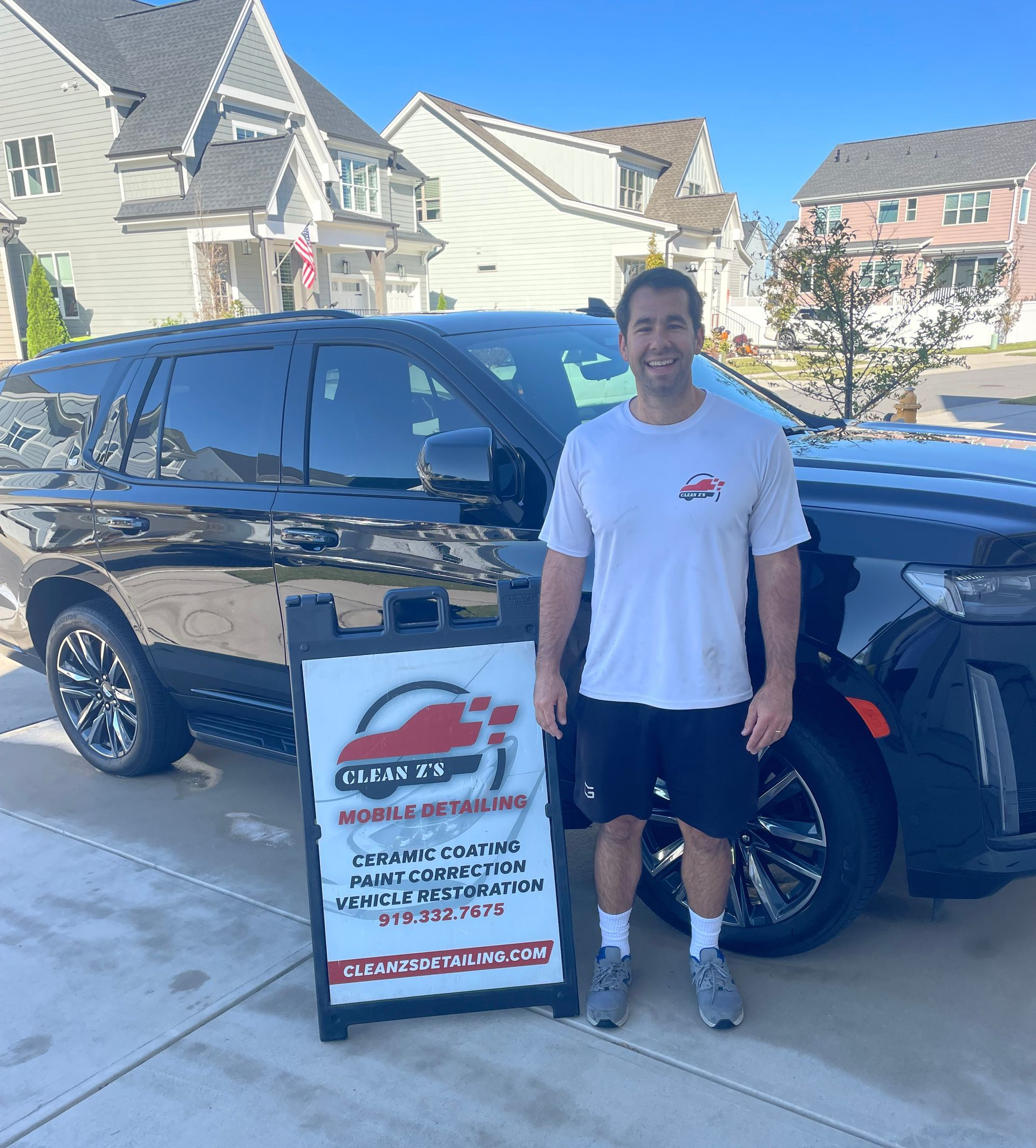 Man stands next to black SUV.
