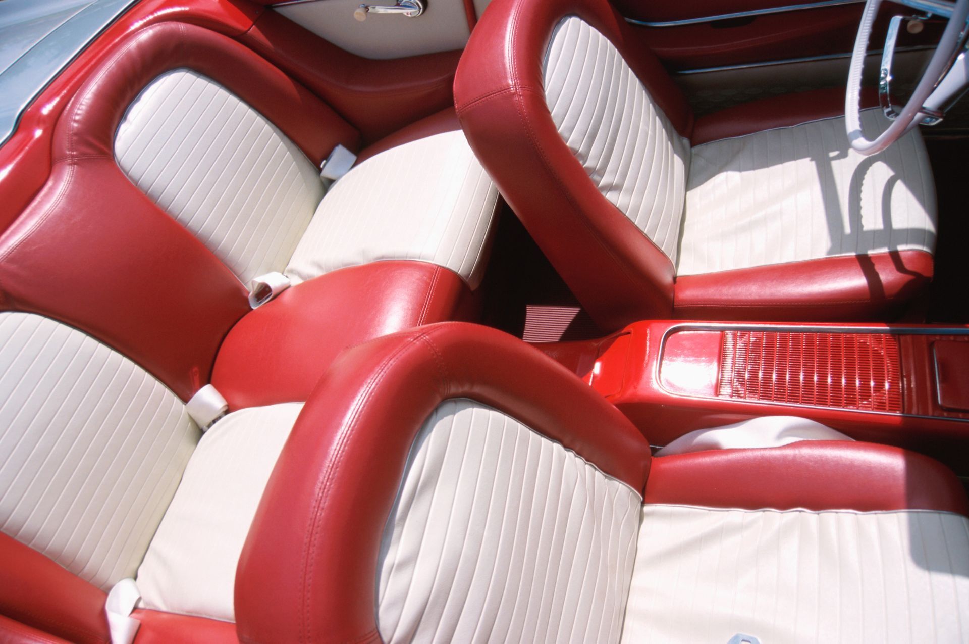 Red and white car interior with leather seats.