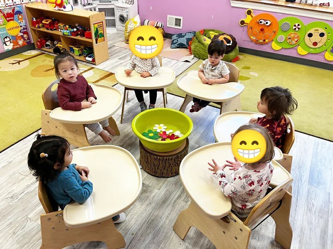 A group of children are sitting at tables in a classroom
