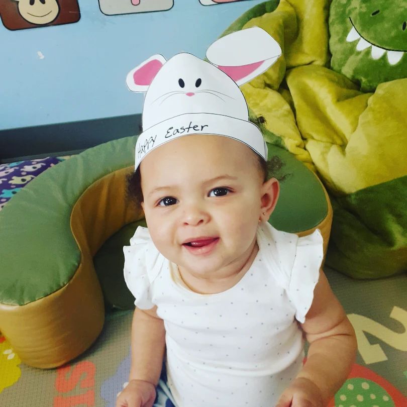 A baby wearing a hat that says happy easter