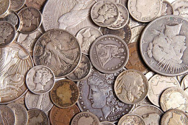 A collection of various vintage American silver coins overlapping on a surface.