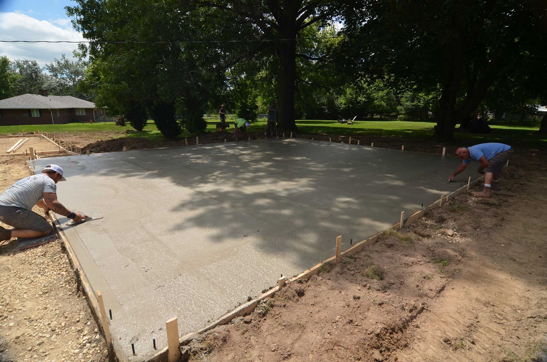 Two workers levelling concrete