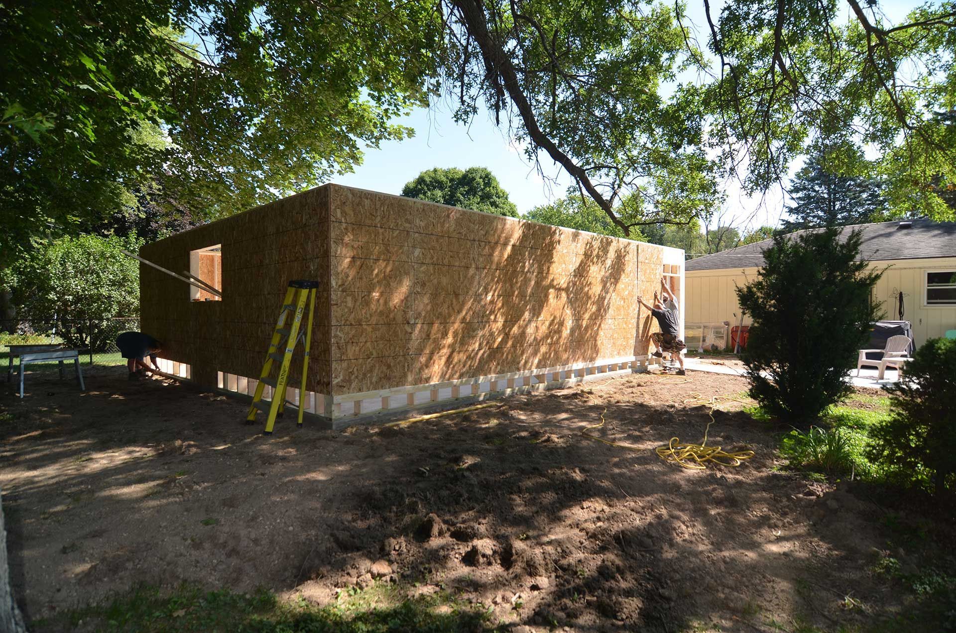 Workers installing OSB wall sheathing