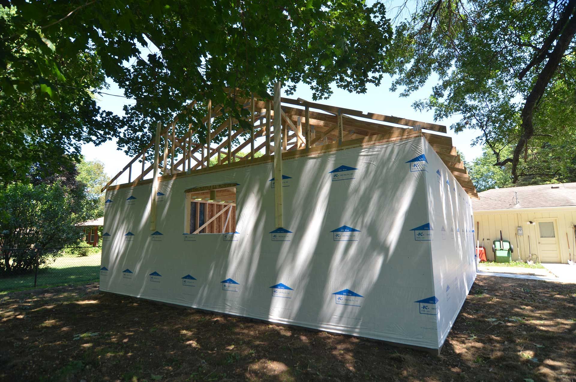 Back view of garage covered in house wrap