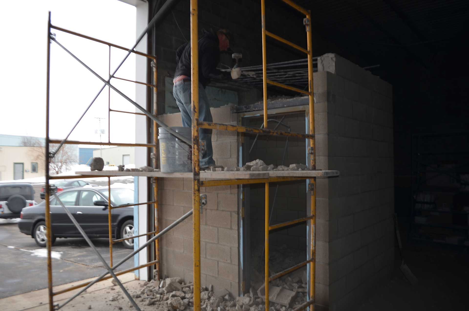 Man creating a small room using bricks