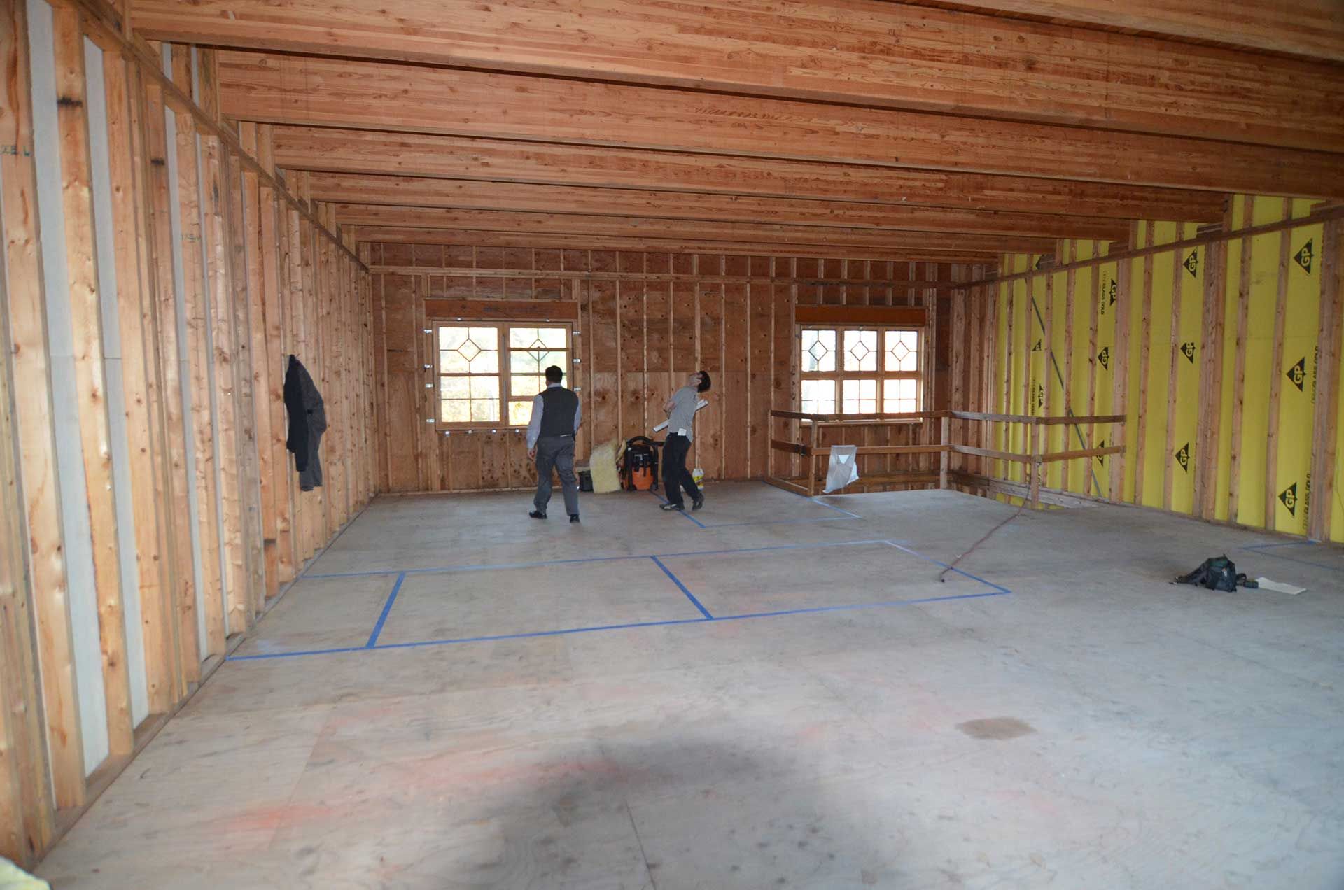 Two men inspecting the interior of a house