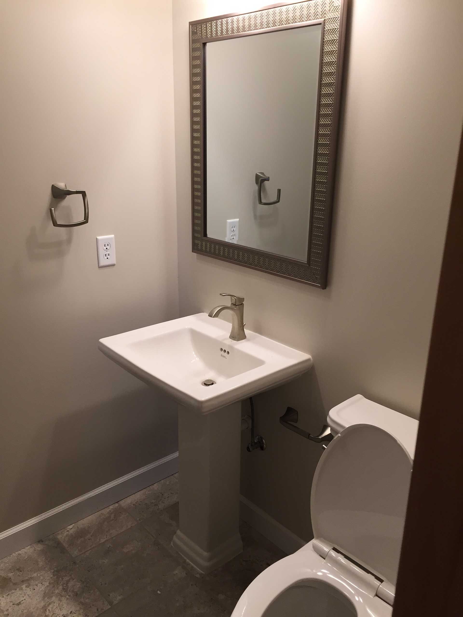 White sink with mirror above it