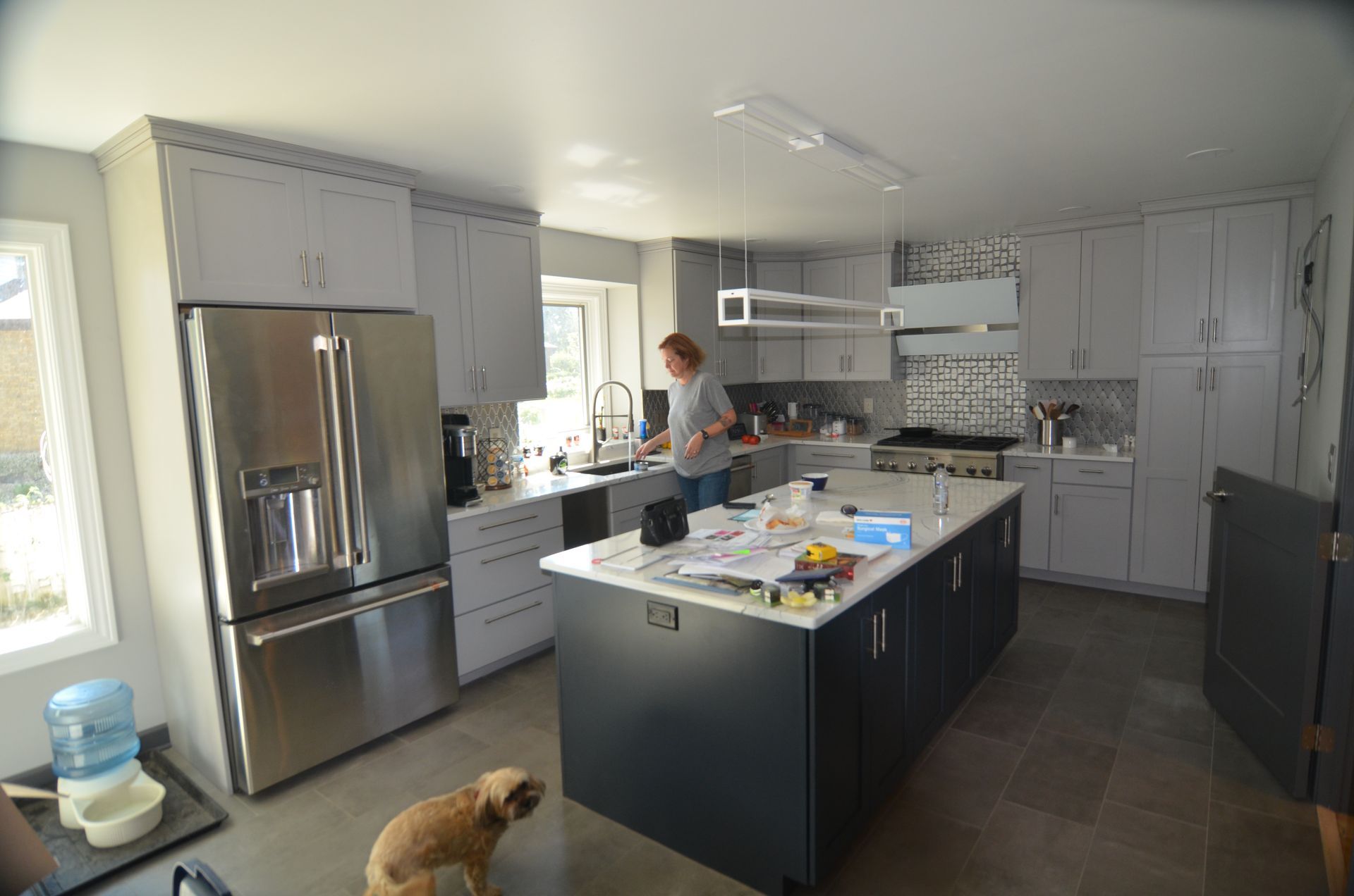 A kitchen with a large island and stainless steel appliances