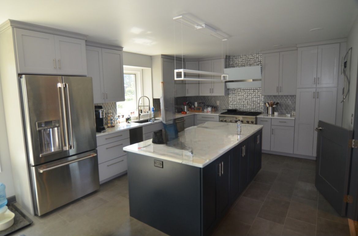 A kitchen with a large island and stainless steel appliances