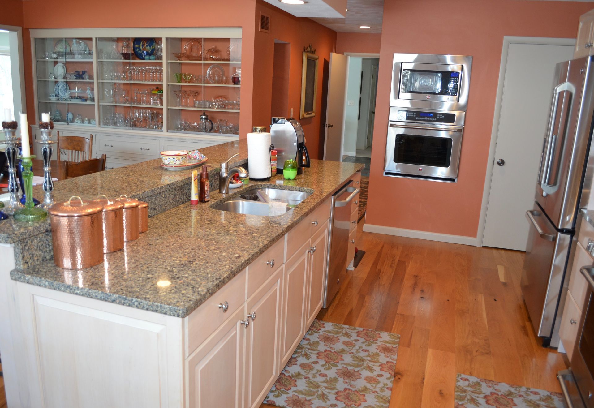 Kitchen with island, granite countertops, stainless steel appliances, and copper canisters.