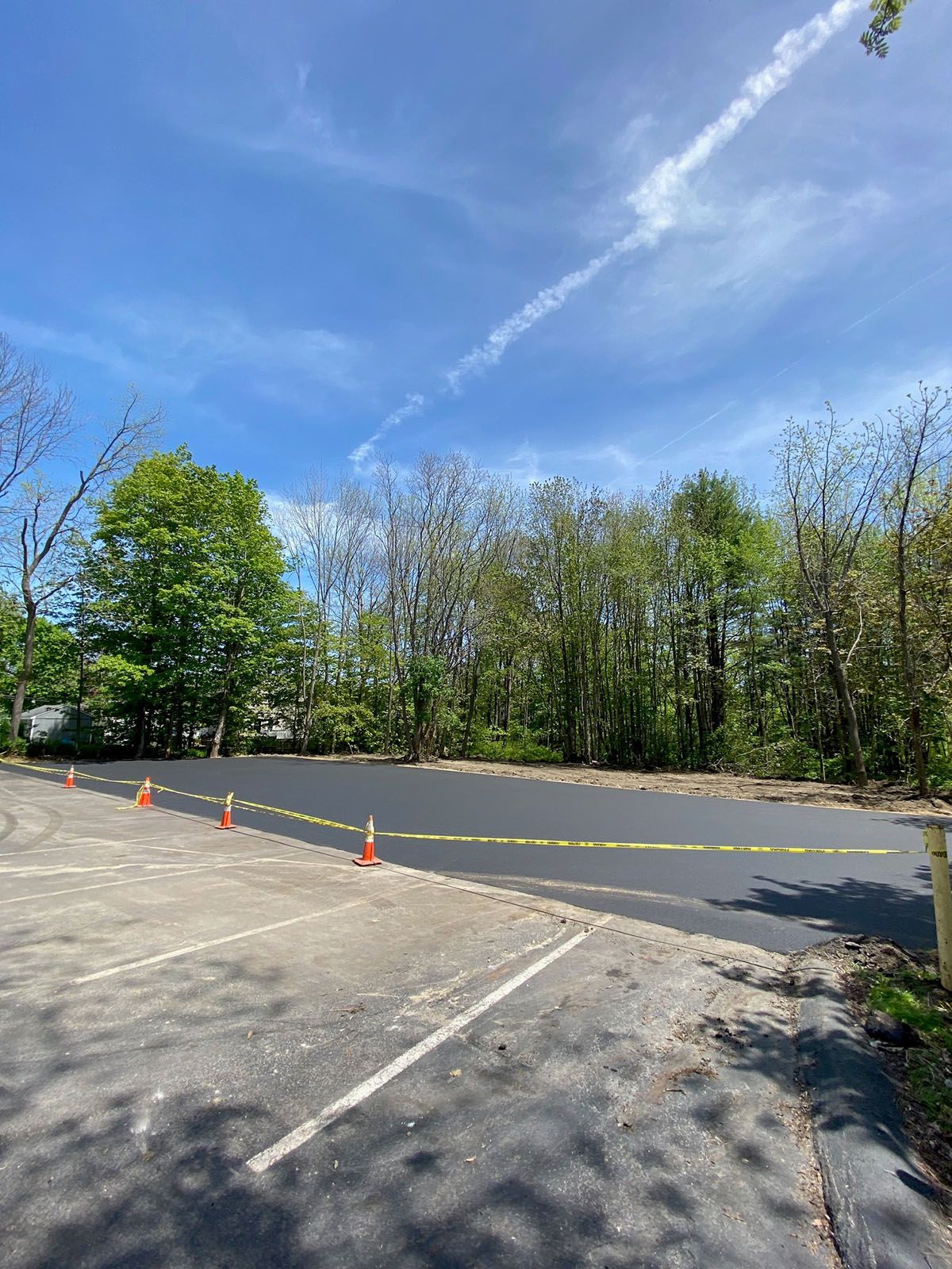 A parking lot with newly paved driveway
