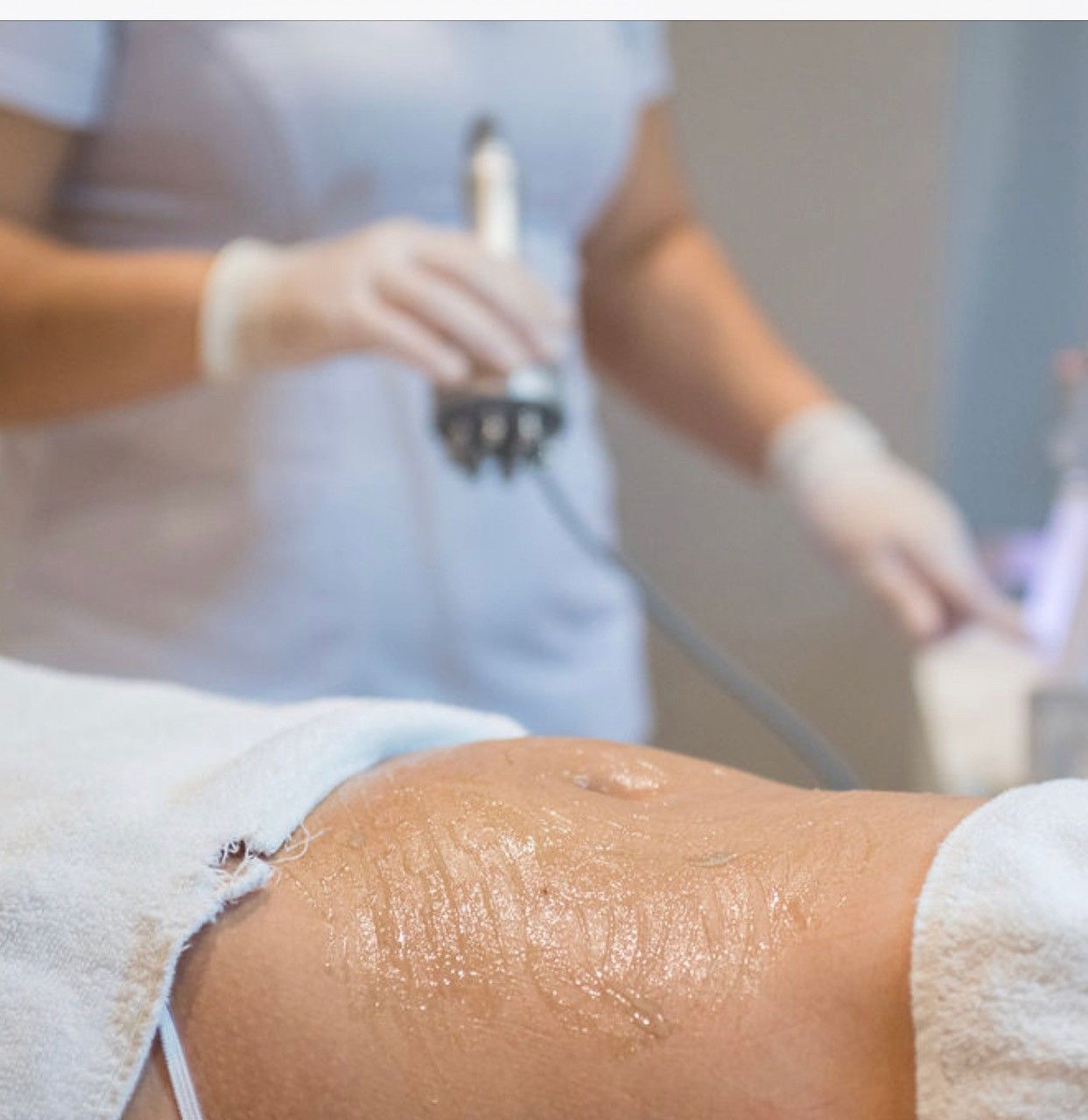 A woman is getting a massage on her stomach in a spa.