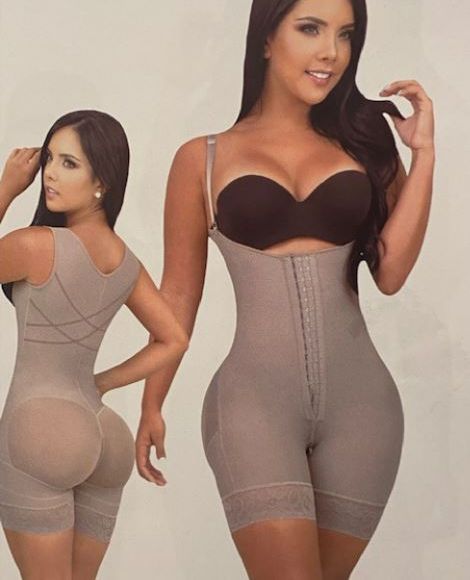 A woman is getting a lymphatic drainage treatment on her legs.